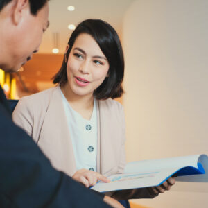 Professional showing financial documents to a client during a business meeting