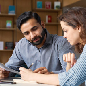 HR professional reviewing onboarding documents with a new employee