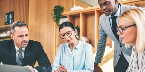 Legal recruiters in a business meeting discussing staffing strategies