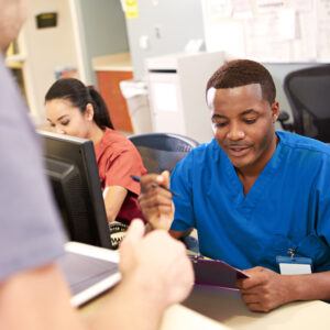 Healthcare professional assisting patient at front desk, representing life sciences executive search and staffing services