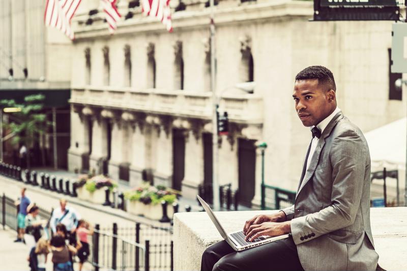 man working on laptop outside
