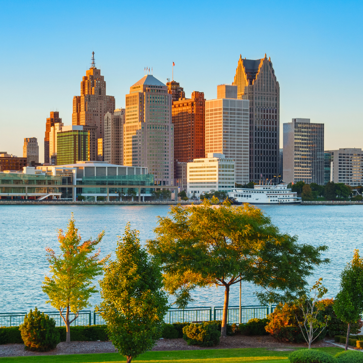 Downtown Detroit, Michigan skyline at sunset with modern skyscrapers and waterfront, showcasing the city's growth and staffing agency presence.
