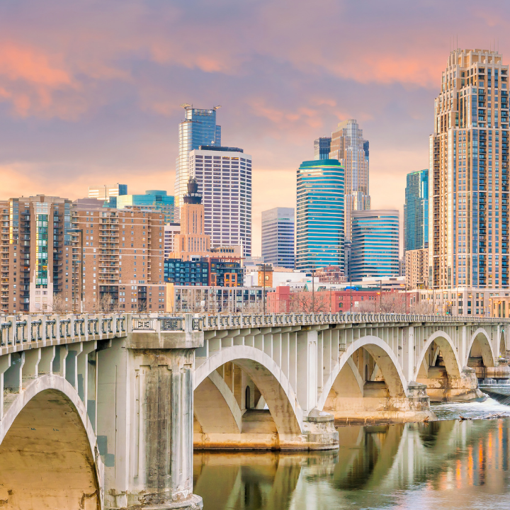 Skyline of the Twin Cities, Minnesota, featuring downtown buildings, a riverfront, and lush greenery—highlighting a vibrant market for staffing services.